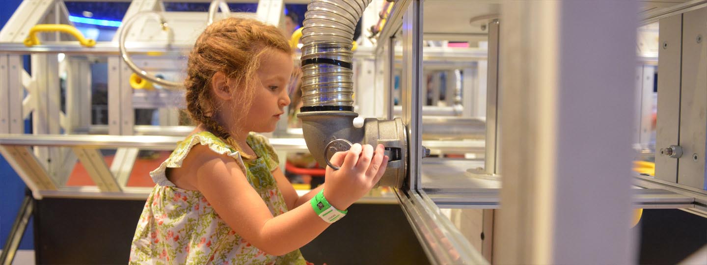 Girl looking through glass in SpacePlace